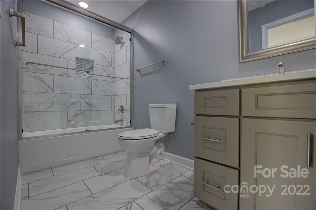 1129 5th Street Lancaster, SC 29720 - Photo 26 of 37 a bathroom with a toilet and a shower