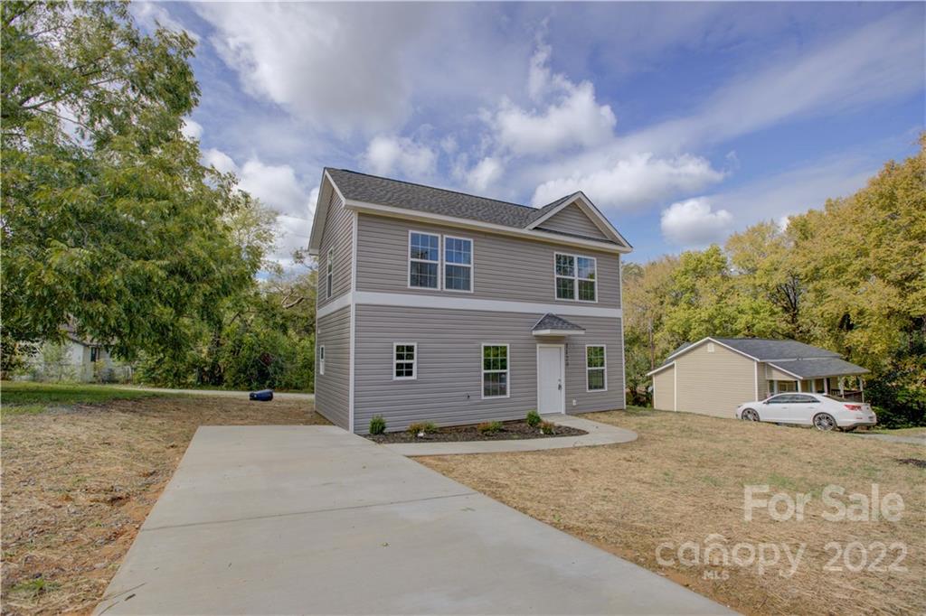1129 5th Street Lancaster, SC 29720 - Photo 4 of 37 a front view of a house with a yard and garage