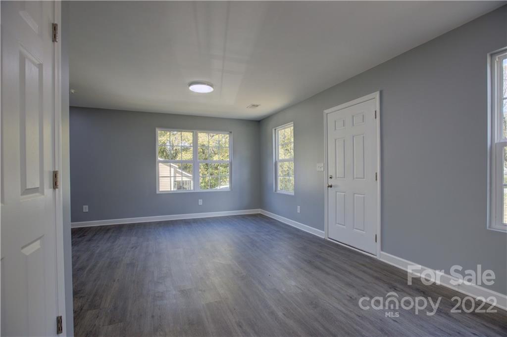 1129 5th Street Lancaster, SC 29720 - Photo 6 of 37 an empty room with wooden floor and windows