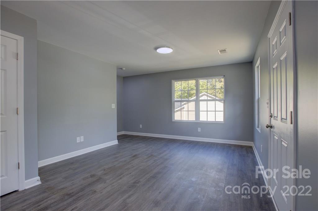 1129 5th Street Lancaster, SC 29720 - Photo 7 of 37 a view of an empty room with wooden floor and a window