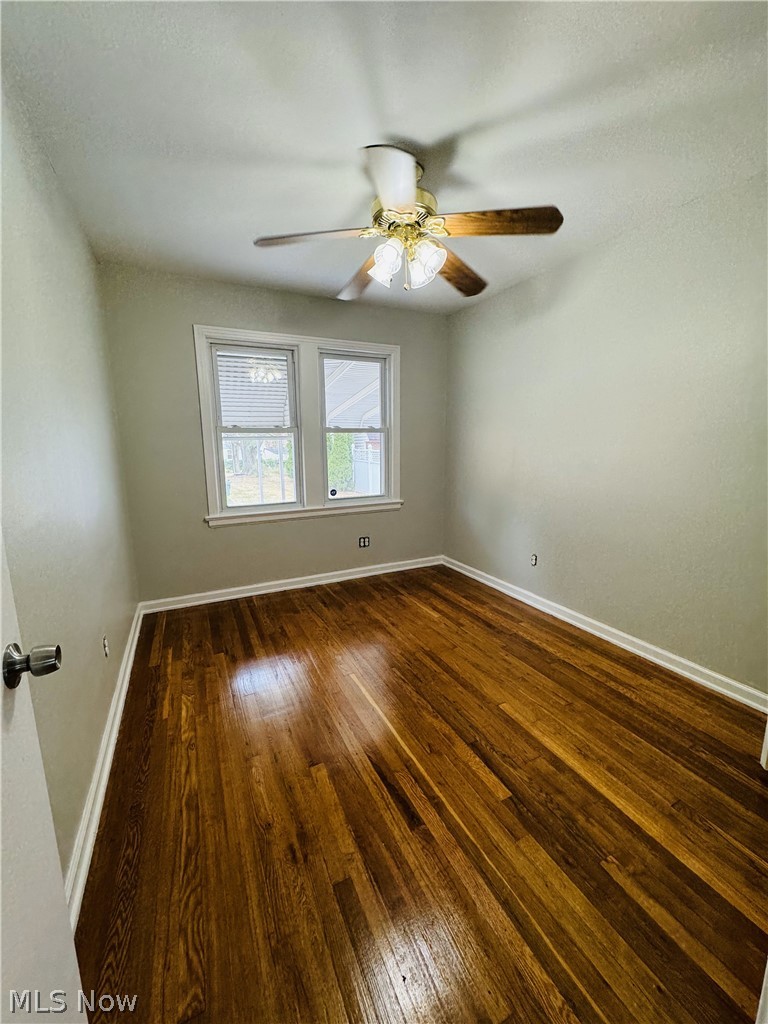 13660 Granger Road Cleveland, OH 44125 - Photo 10 of 17 Spare room featuring ceiling fan and wood-type flooring