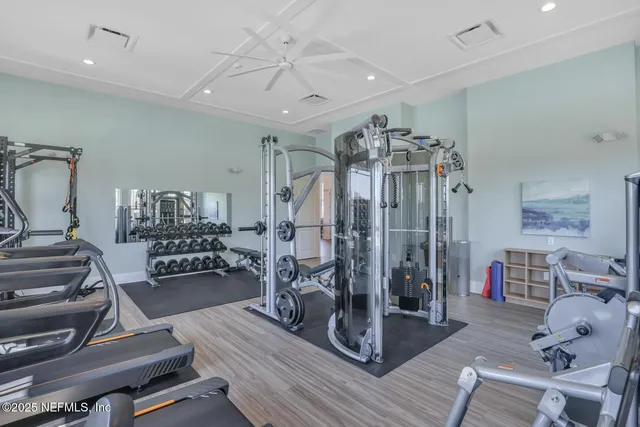 a view of a livingroom with furniture and a gym cycle