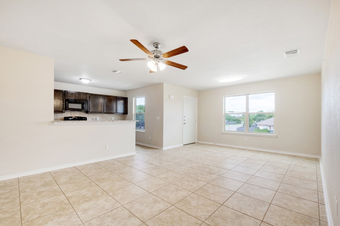 a view of a kitchen with microwave and cabinets