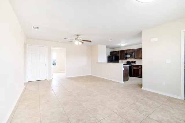 a view of a kitchen with a sink and a refrigerator