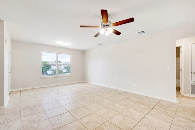 a view of room with window and ceiling fan