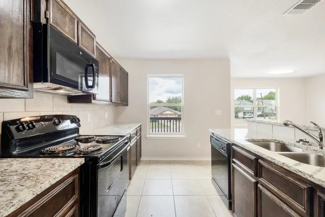 a kitchen that has a sink and a stove