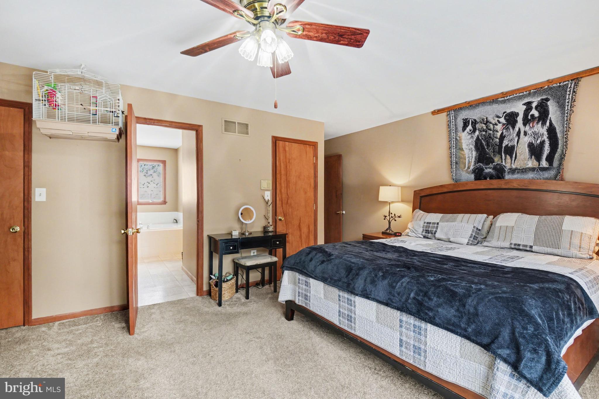 46 Wetzel Road Macungie, PA 18062 - Photo 13 of 42 a bedroom with a large bed and a chandelier