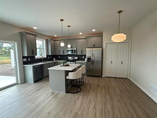 a kitchen with a sink appliances and cabinets