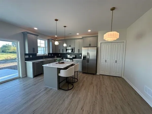 a kitchen with a sink appliances and cabinets