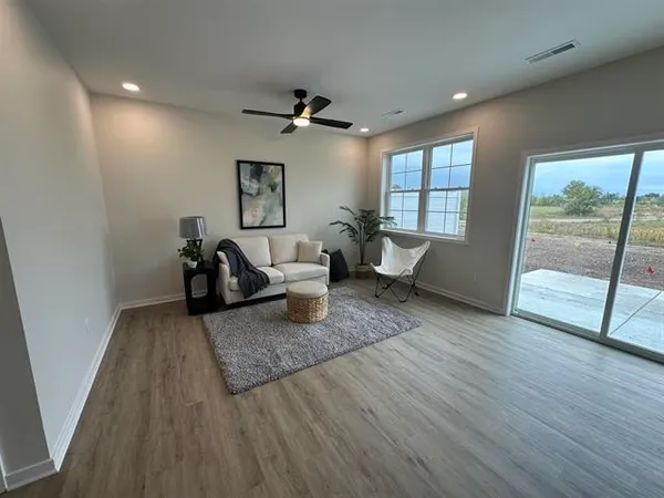 a living room with furniture and wooden floor
