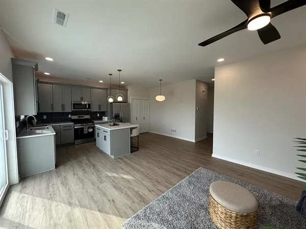 a living room with furniture and a potted plant
