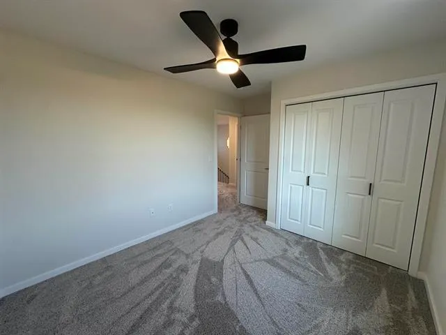 a living room with furniture and a ceiling fan