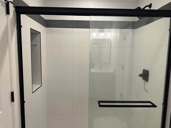 a bathroom with a glass shower door