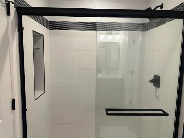 a bathroom with a glass shower door