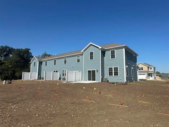a front view of a house with a garden and garage