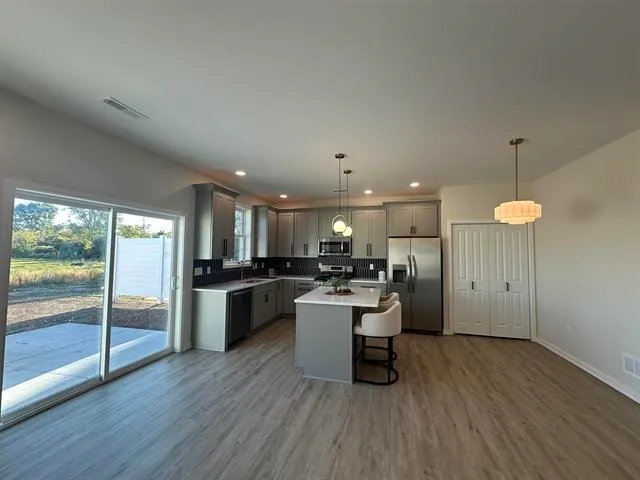 an open kitchen with a table and chairs
