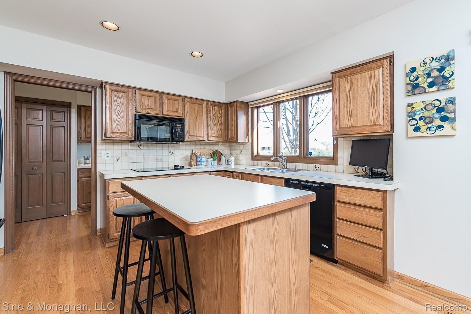 4906 Rivers Edge Drive Troy, MI 48098 - Photo 27 of 60 Tiled backsplash, recessed lighting, large window over sink area