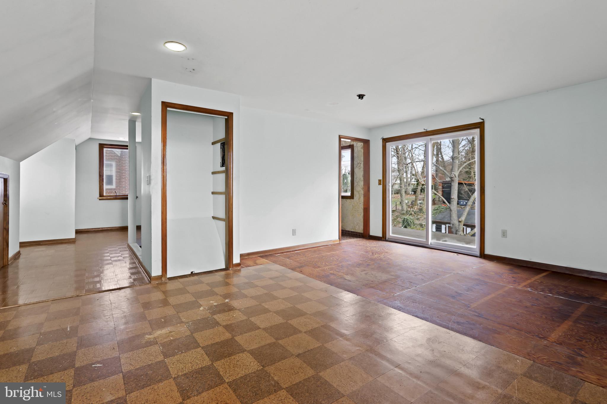 409 Oak Court Baltimore, MD 21228 - Photo 17 of 29 a view of an empty room with window and wooden floor