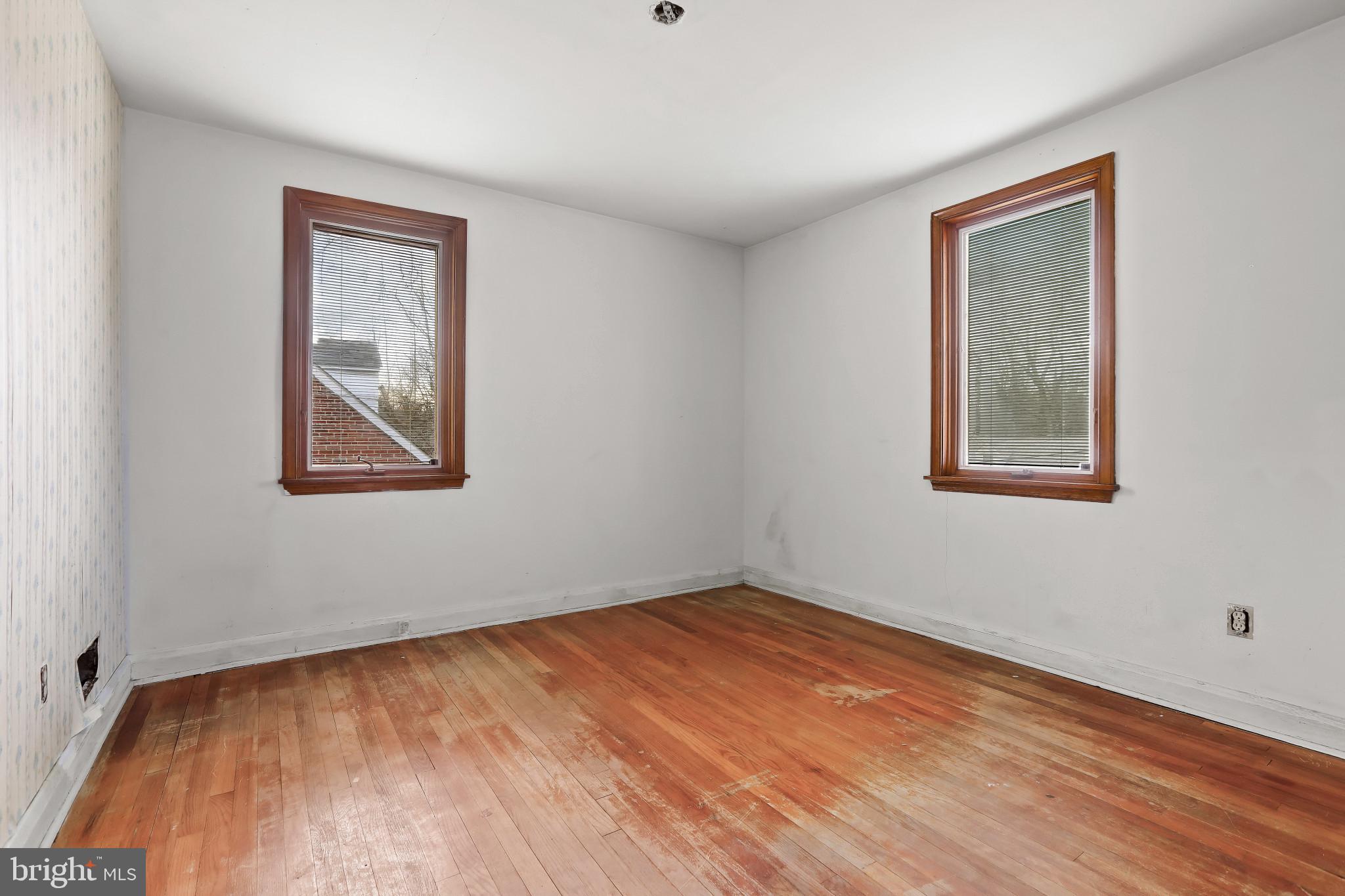 409 Oak Court Baltimore, MD 21228 - Photo 8 of 29 a view of an empty room with wooden floor and a window