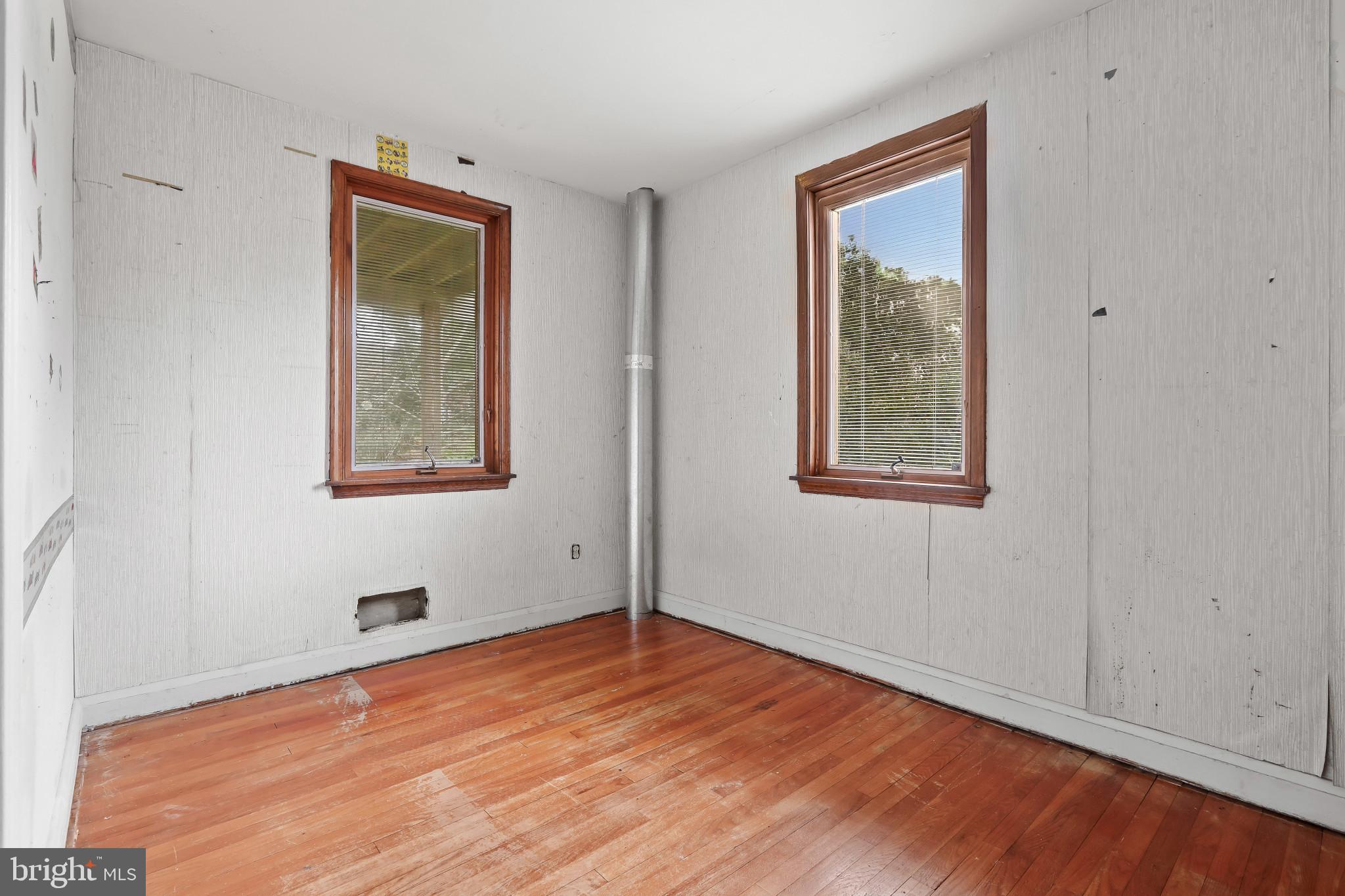 409 Oak Court Baltimore, MD 21228 - Photo 10 of 29 a view of an empty room with wooden floor and a window