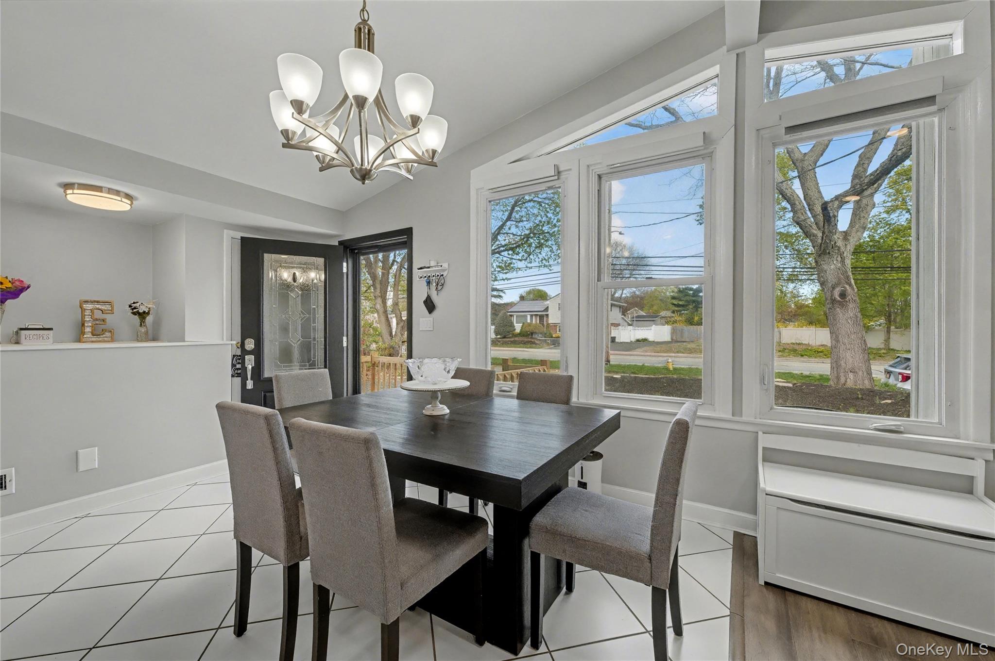 1298 Pulaski Road East Northport, NY 11731 - Photo 12 of 41 a view of a dining room with furniture a chandelier and wooden floor