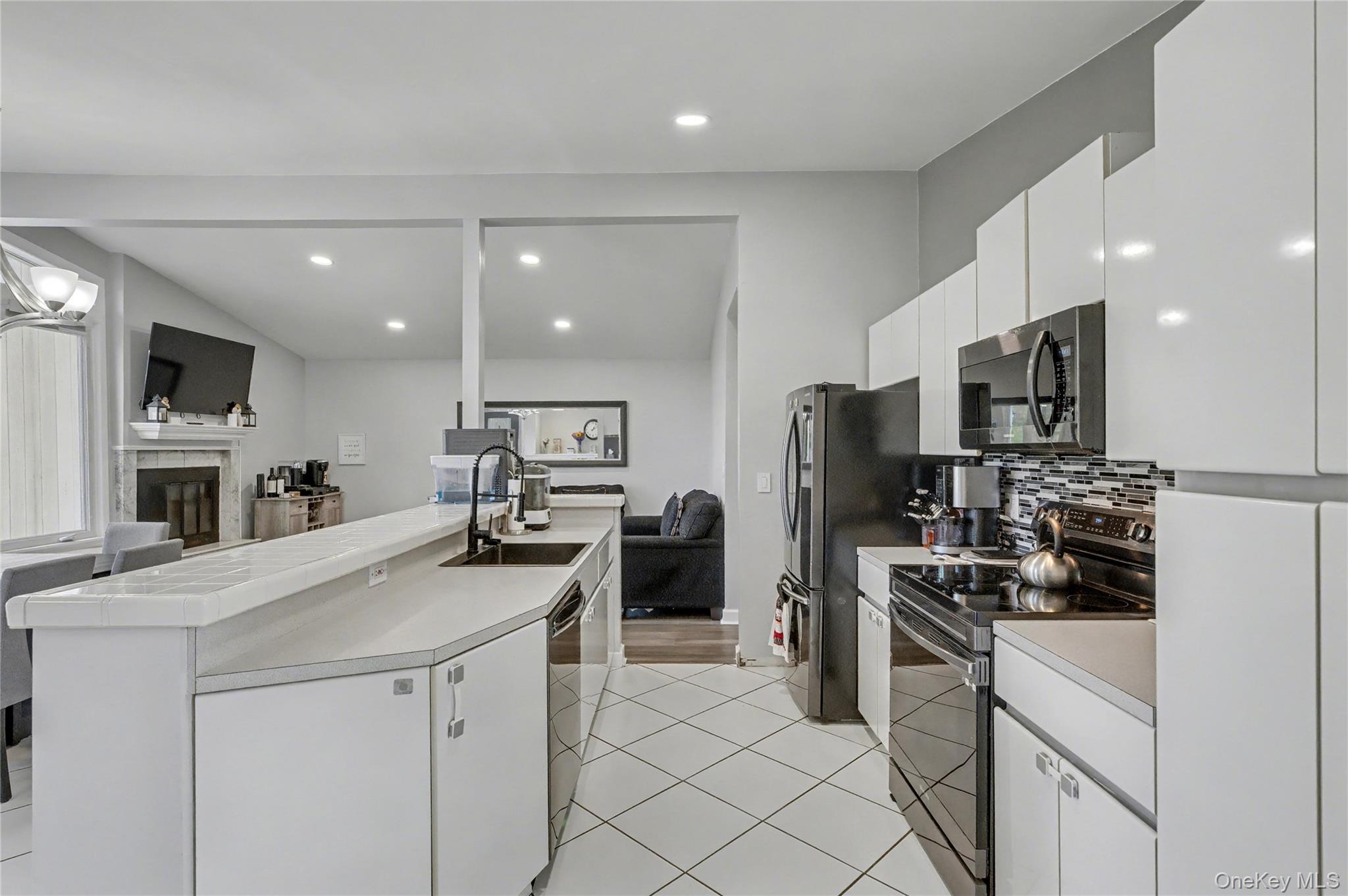 1298 Pulaski Road East Northport, NY 11731 - Photo 16 of 41 a kitchen with a sink stainless steel appliances and cabinets