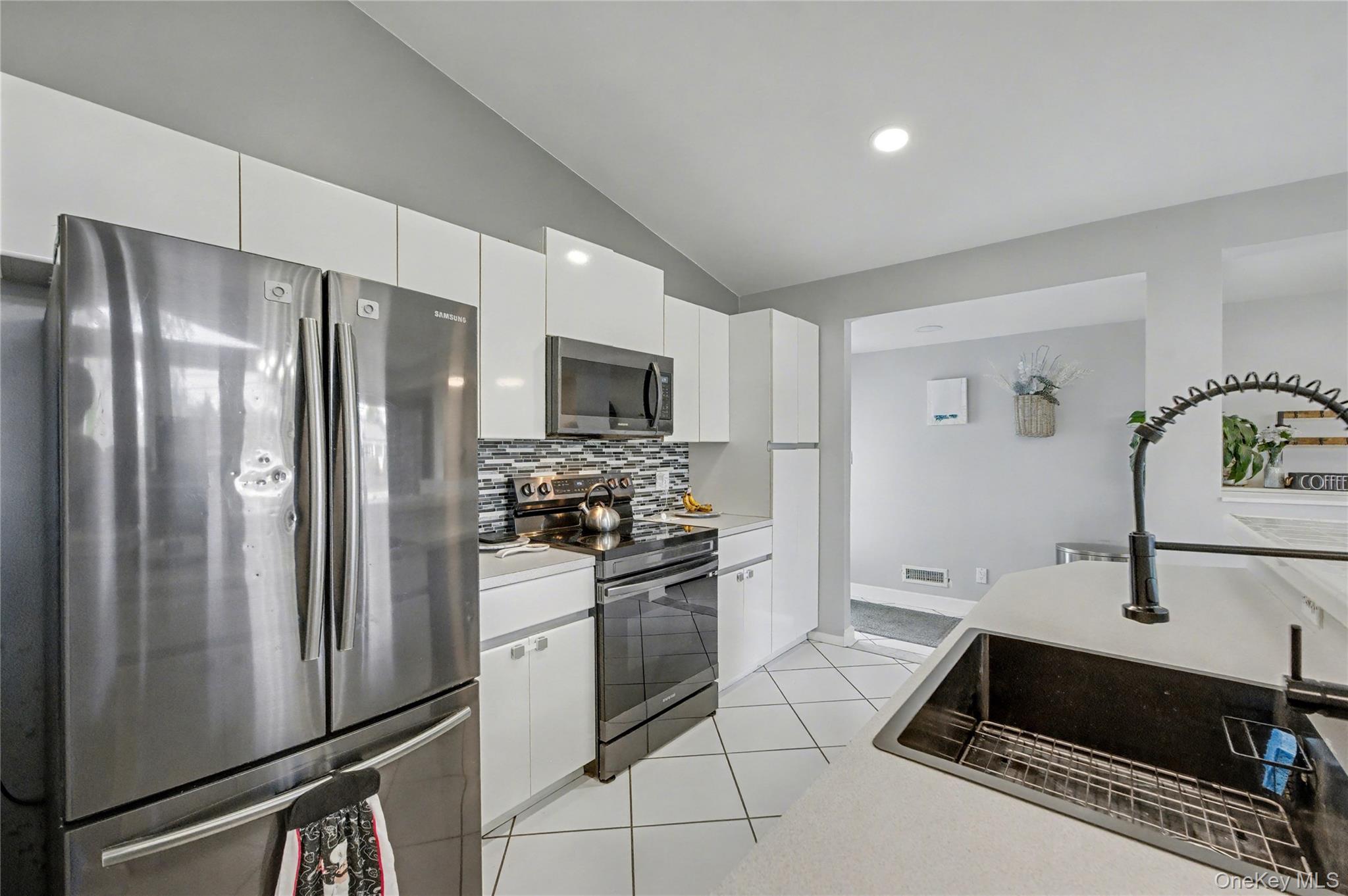 1298 Pulaski Road East Northport, NY 11731 - Photo 19 of 41 a kitchen with stainless steel appliances a refrigerator sink and stove