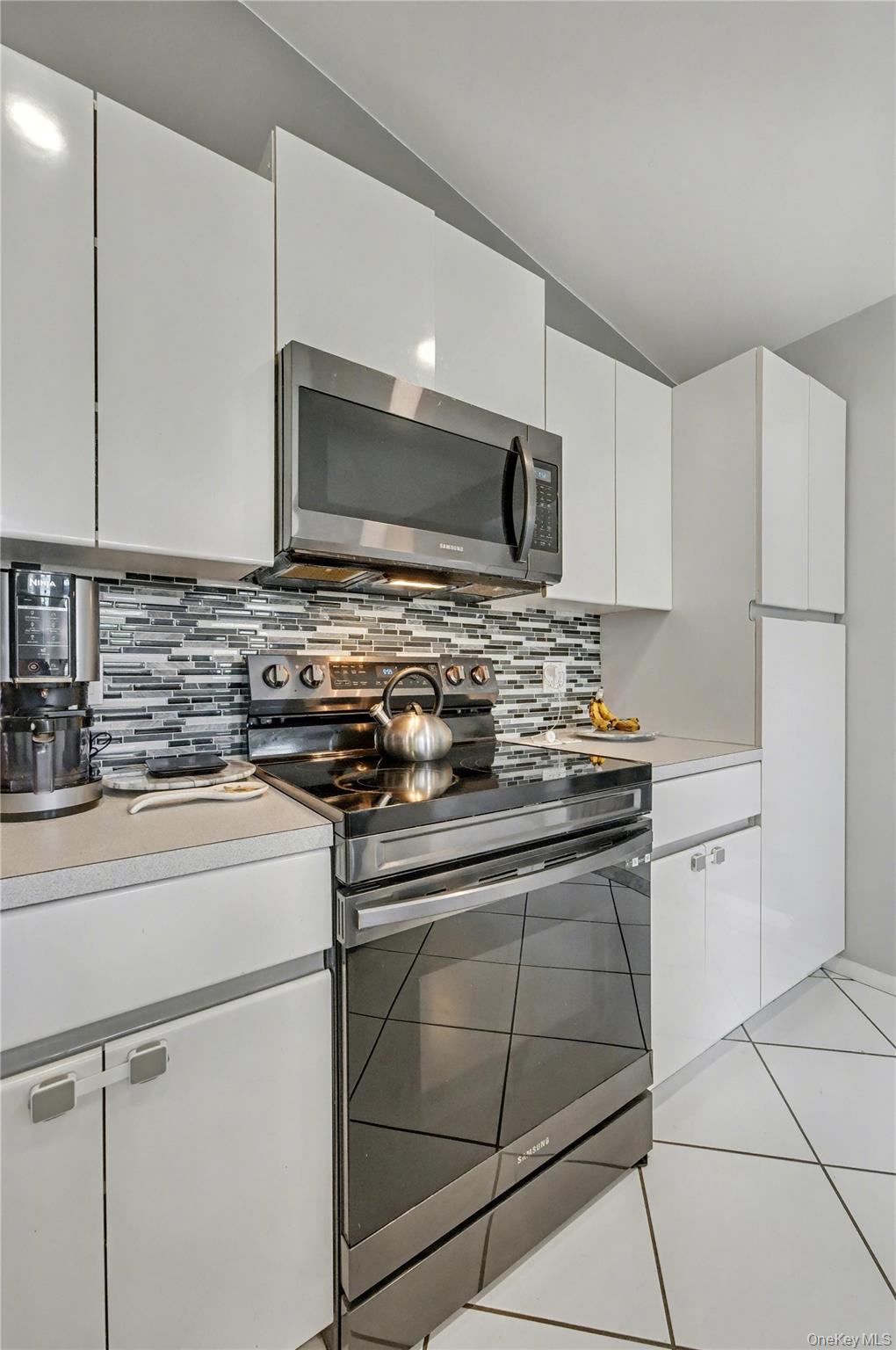 1298 Pulaski Road East Northport, NY 11731 - Photo 20 of 41 a kitchen with kitchen island granite countertop a sink cabinets and stainless steel appliances
