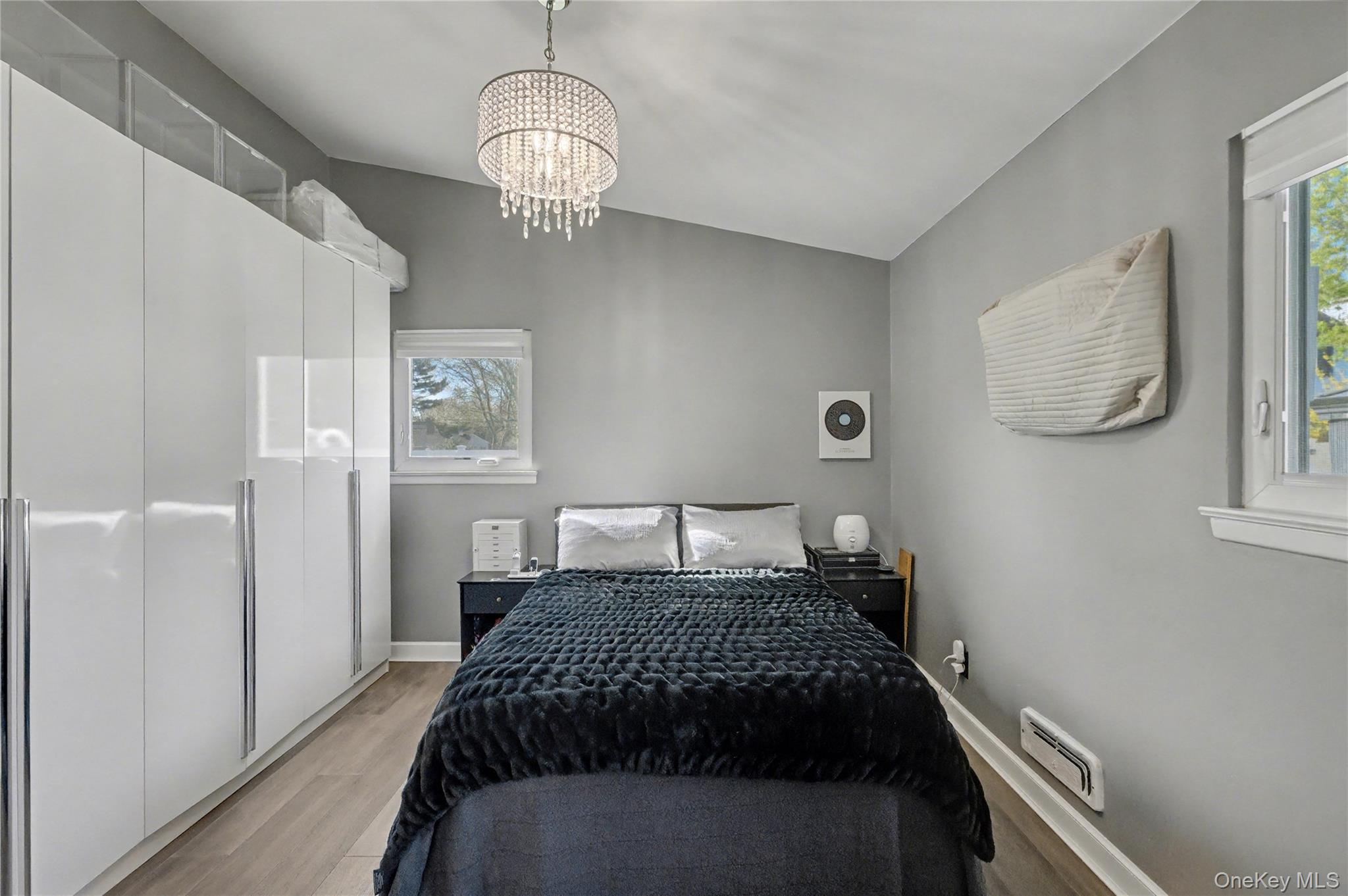 1298 Pulaski Road East Northport, NY 11731 - Photo 22 of 41 a bedroom with a bed and wooden floor