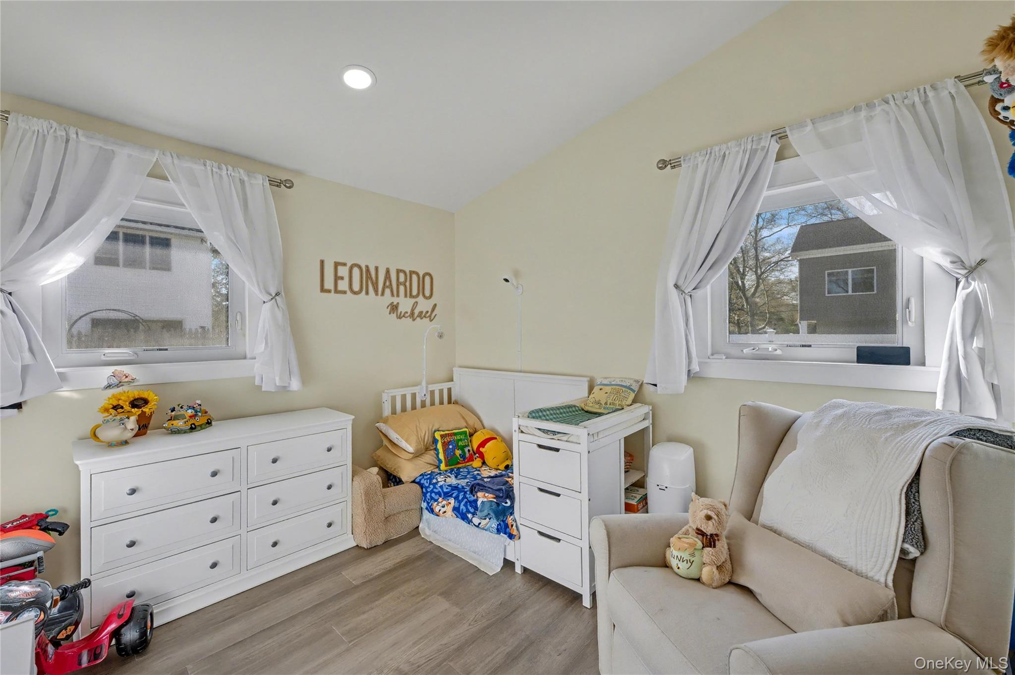 1298 Pulaski Road East Northport, NY 11731 - Photo 23 of 41 a living room with furniture and a baby crib