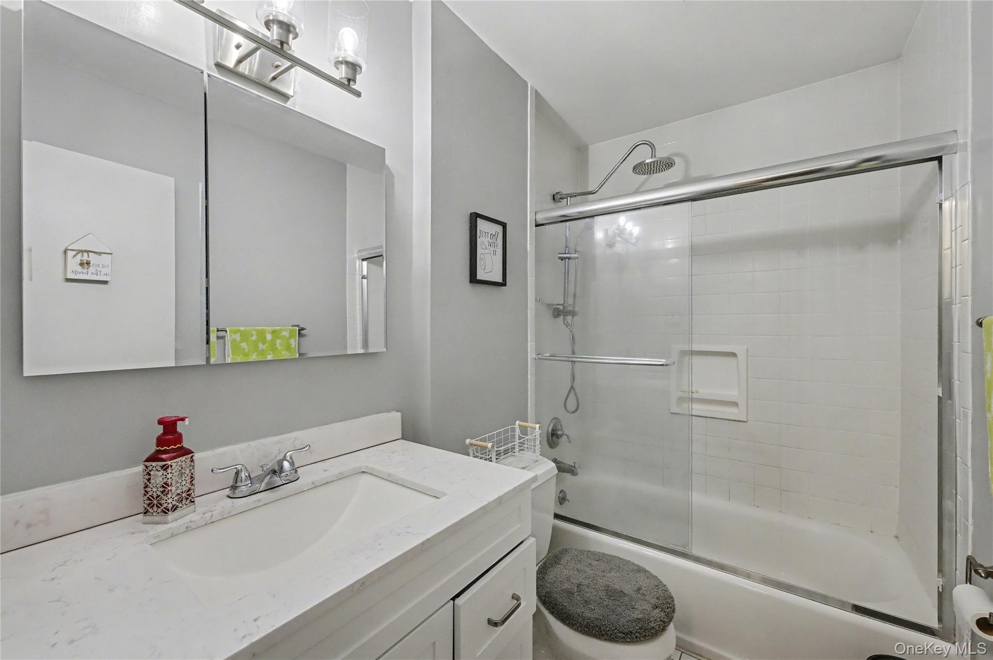 1298 Pulaski Road East Northport, NY 11731 - Photo 25 of 41 a bathroom with a sink toilet and shower