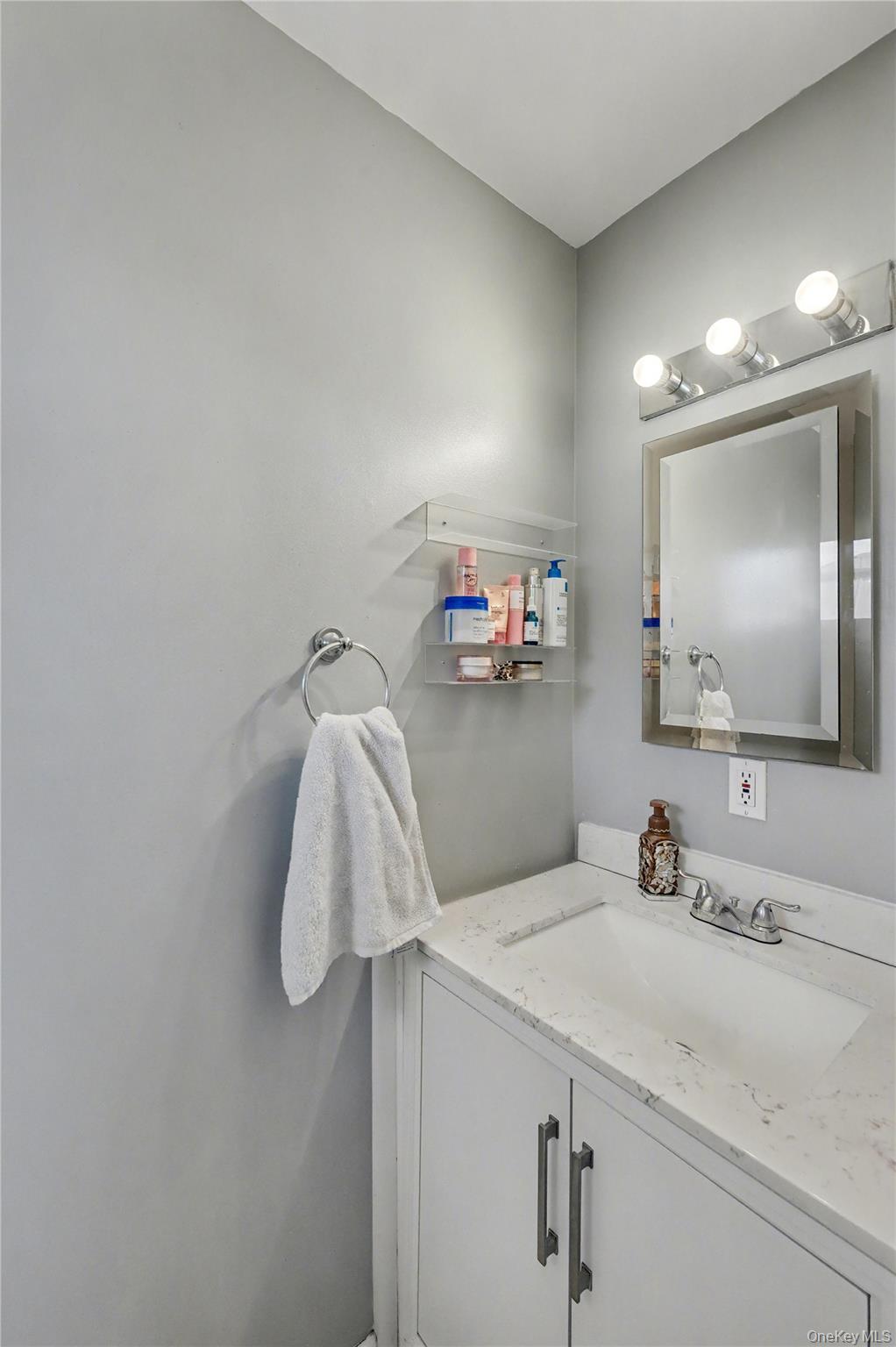 1298 Pulaski Road East Northport, NY 11731 - Photo 26 of 41 a bathroom with a sink and a mirror