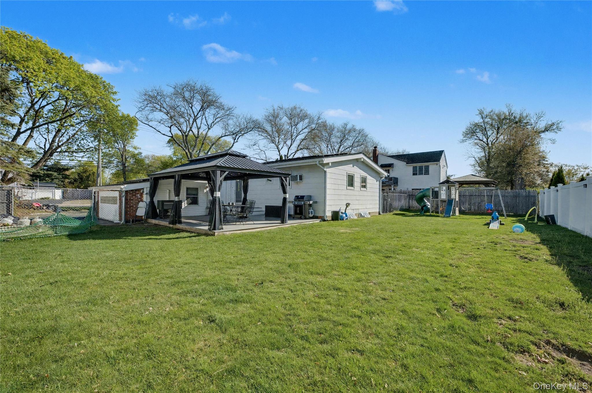 1298 Pulaski Road East Northport, NY 11731 - Photo 36 of 41 a front view of a house with a garden