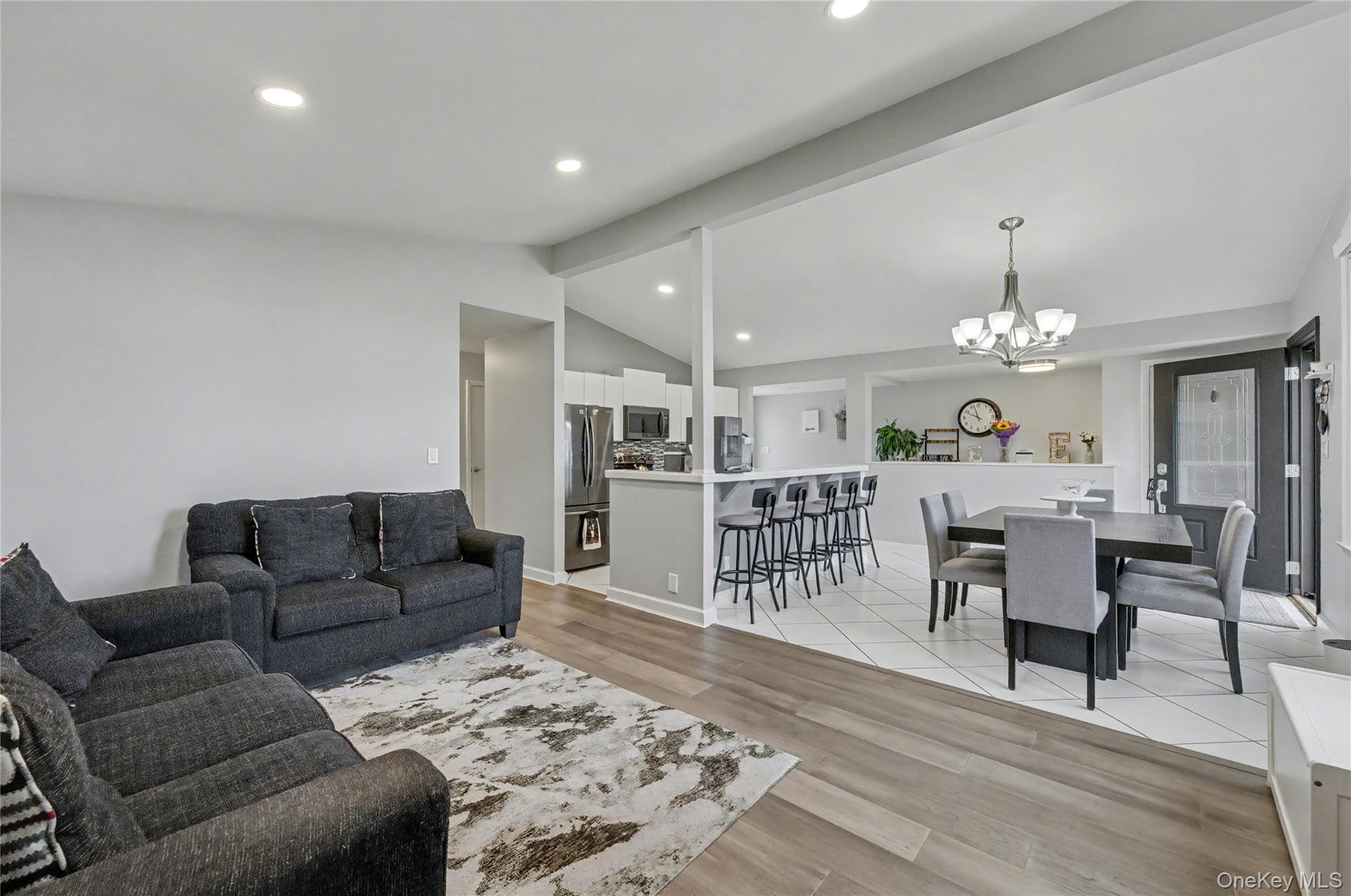 1298 Pulaski Road East Northport, NY 11731 - Photo 8 of 41 a living room with furniture a dining table and a rug