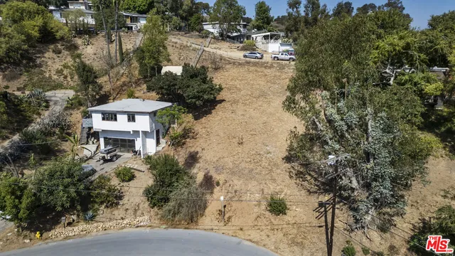an aerial view of a house with a yard