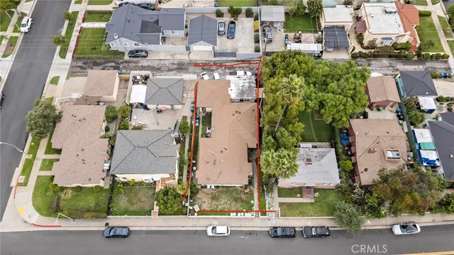 an aerial view of multiple houses with yard