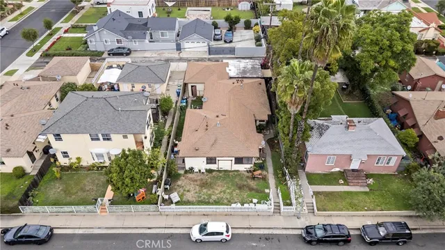 an aerial view of multiple houses with yard