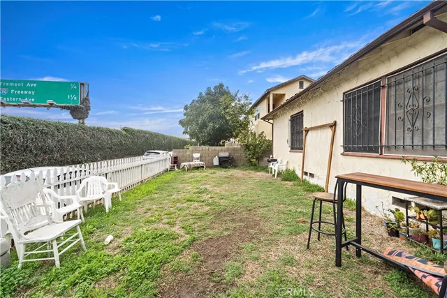 a view of an house with backyard space and garden