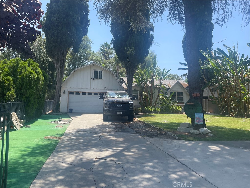 7994 Magnolia Avenue Riverside, CA 92504 - Photo 1 of 1 a view of a house with backyard and a tree