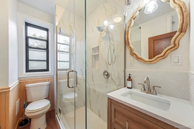 a bathroom with a sink toilet and shower