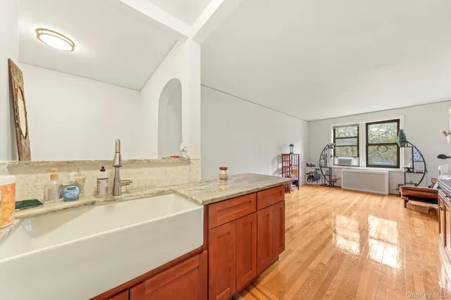 a bathroom with a sink and two mirror