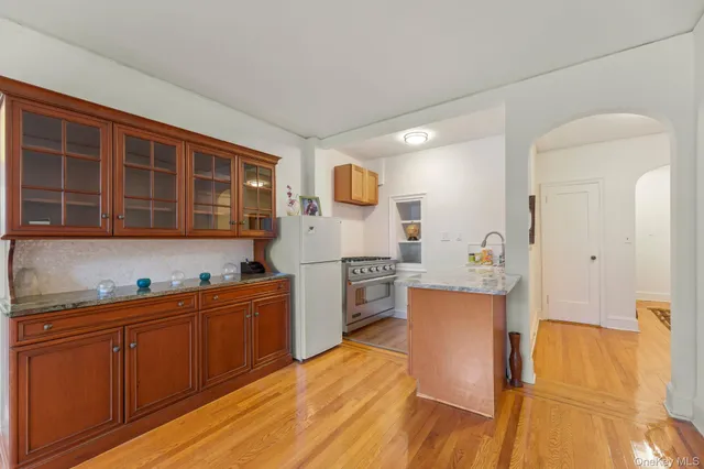 a large kitchen with stainless steel appliances a sink and cabinets