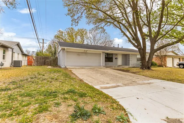a front view of house with yard and trees around