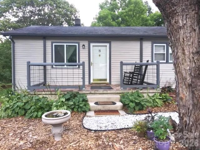 a view of a back yard of the house with a fountain