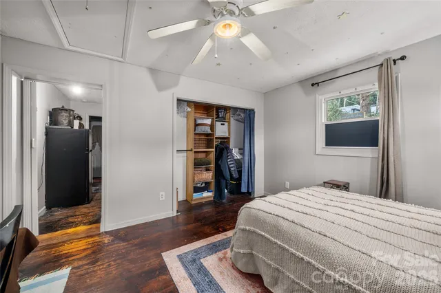 a bedroom with a large bed and a chandelier