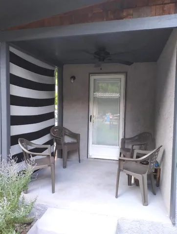 a living room with a chair and chairs