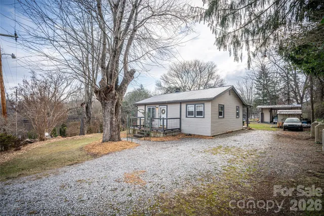 a view of a house with a yard covered in snow