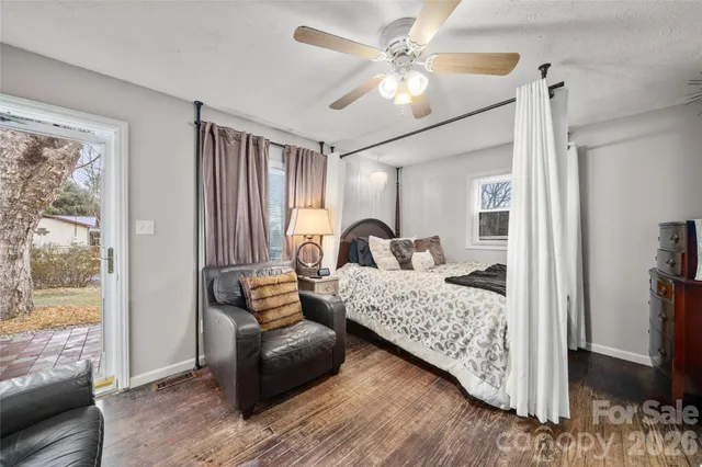 a bedroom with furniture and wooden floor