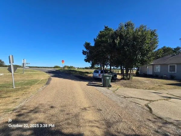 an empty room with wooden floor & windows & cabinet