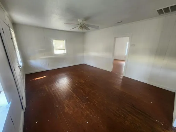 a kitchen with a refrigerator and white cabinets